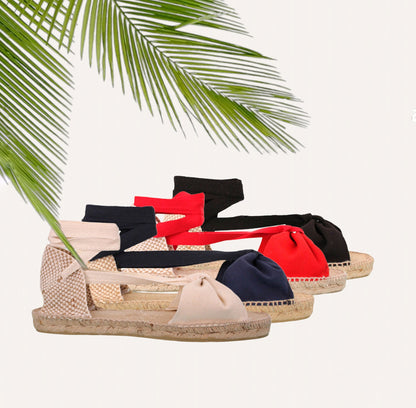 Flache Espadrilles aus schwarzem Canvas mit Schmetterlingsmotiv.